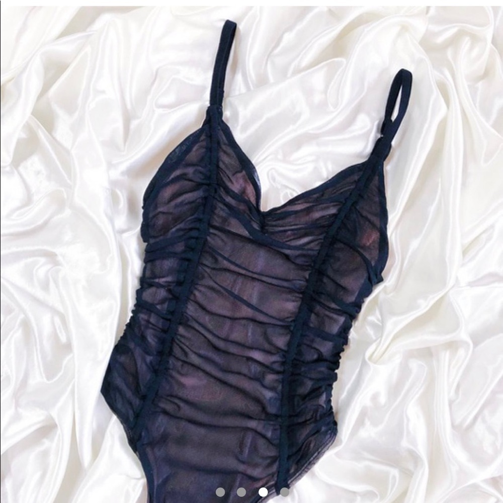 Black ruched thong bodysuit by OUT FROM UNDER.